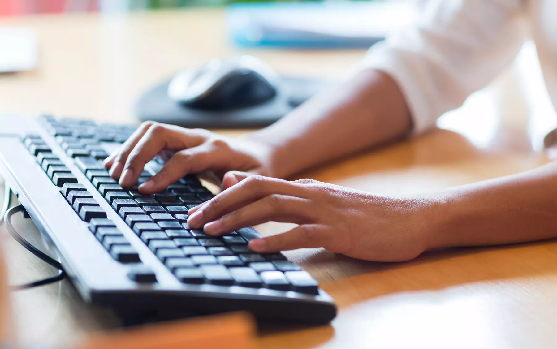 hands typing on a keyboard