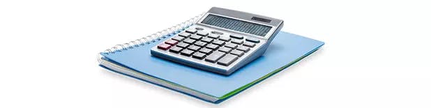 Calculator and on a blue notebook on a white background / Calculatrice et cahier bleu sur fond blanc